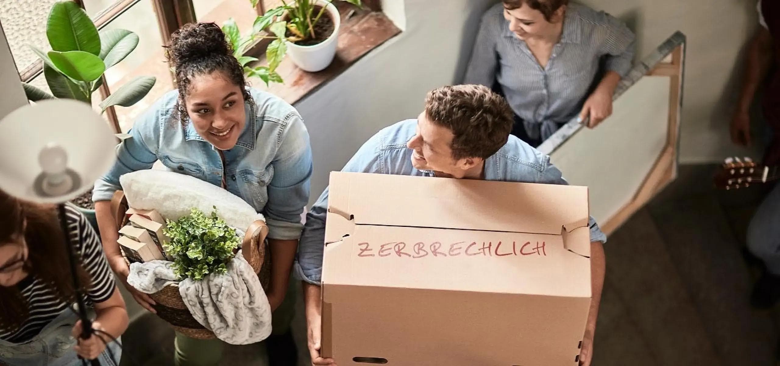 a group of people are moving into a new house .