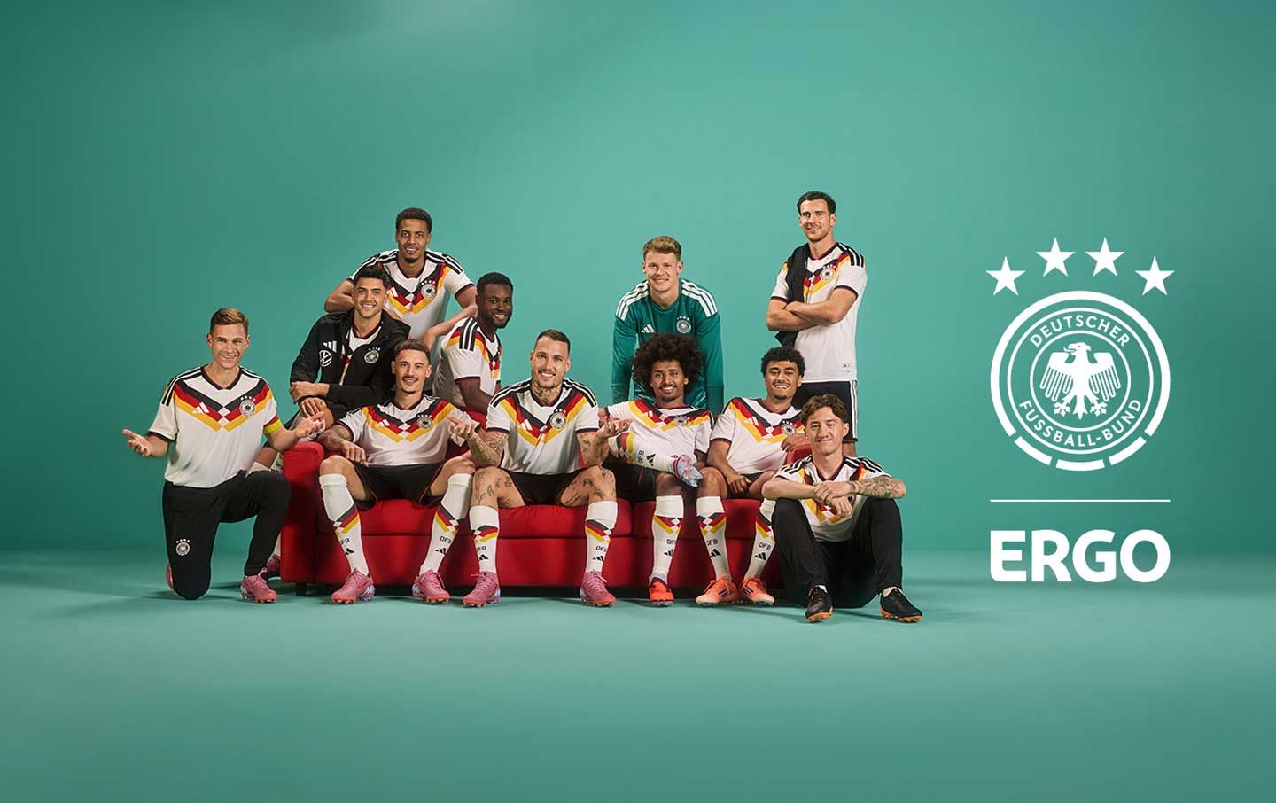 German national football team players pose on a red couch, with DFB and ERGO logos.